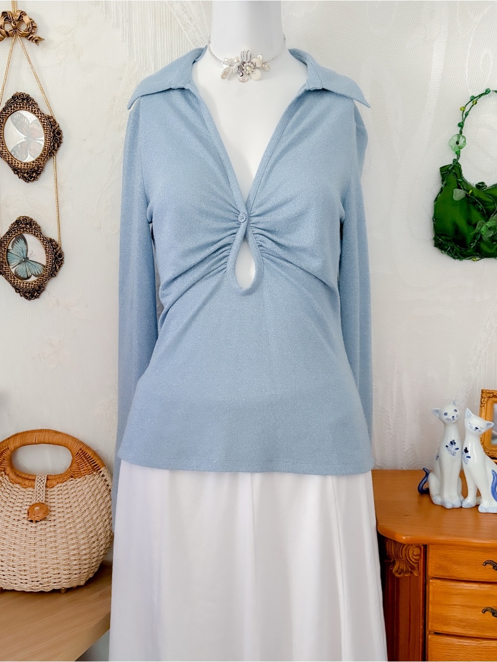 Effortless model off-duty casual girly shimmery blue ruched button front top